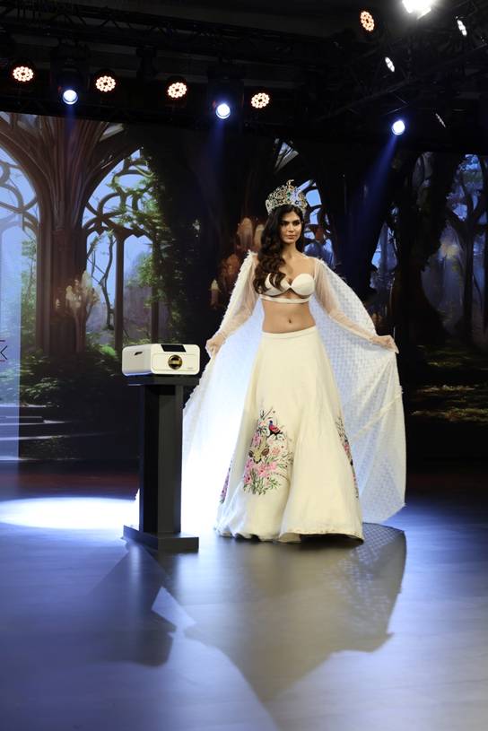 A product/device is placed on a pedestal beside her, indicating it is the focus of the event