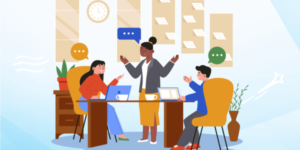 Three professionals are sitting around a table in an office setting. priushealthcare